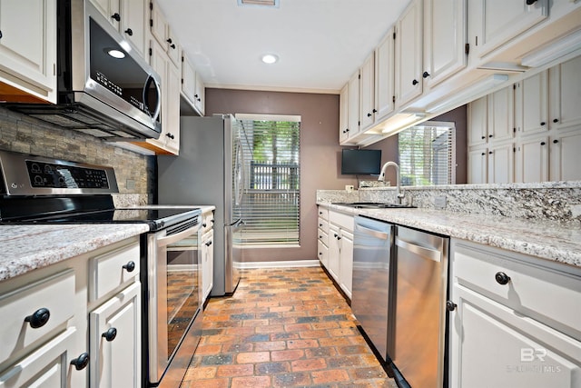 6 Pirates Ln, Spanish Fort, AL 36527 - kitchen featuring appliances with stainless steel finishes, brick floors, plenty of natural light, white cabinetry, and recessed lighting
