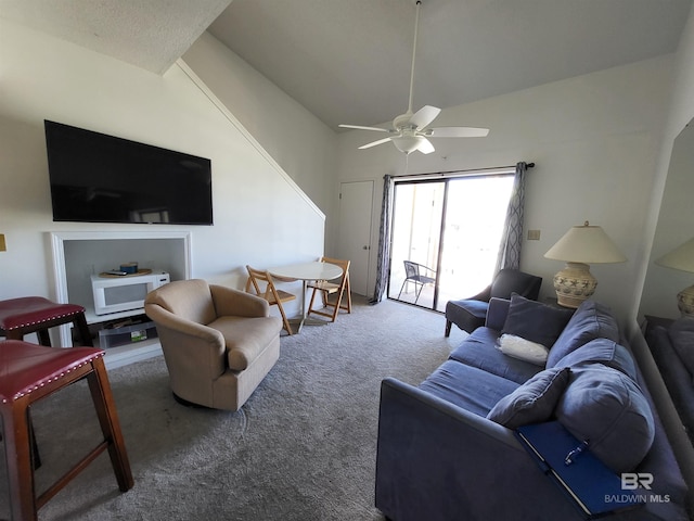 carpeted living room with high vaulted ceiling and ceiling fan