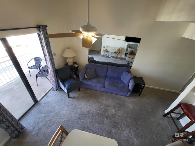 carpeted living room with ceiling fan