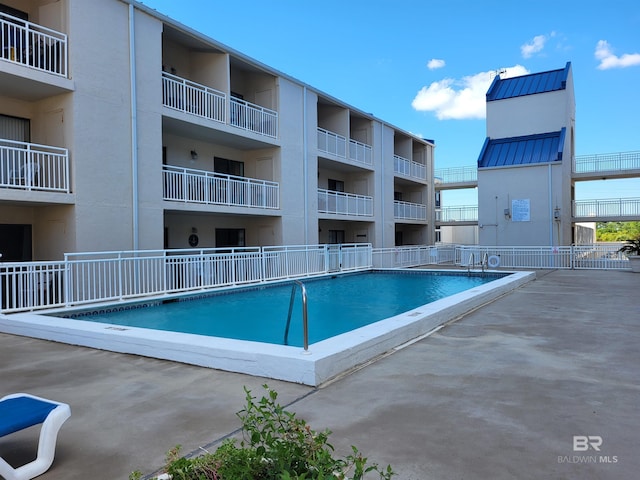 view of swimming pool featuring a patio