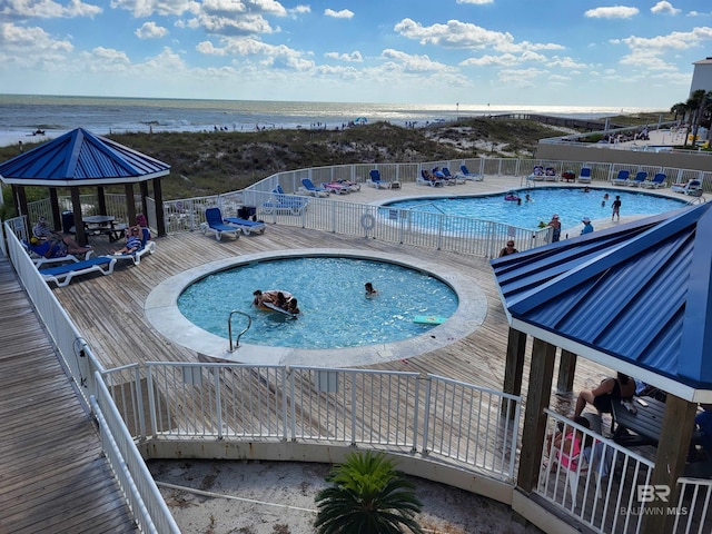 view of swimming pool with a patio, a gazebo, and a water view