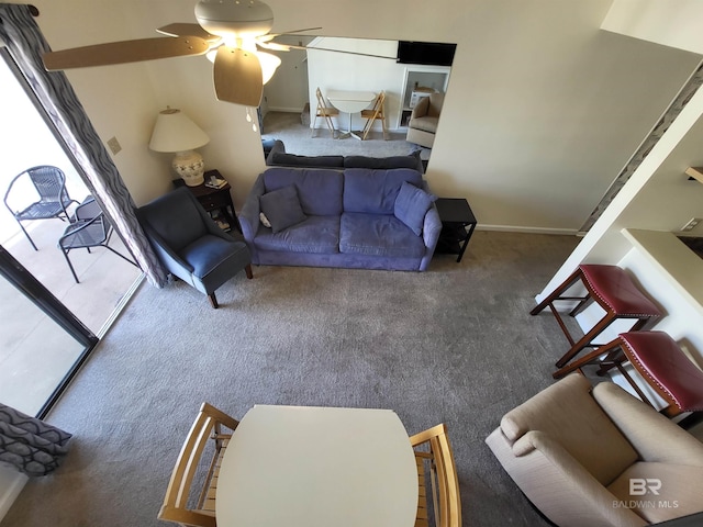 living room featuring ceiling fan and carpet