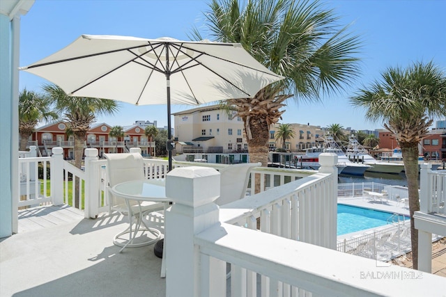 view of patio / terrace featuring a water view and a community pool