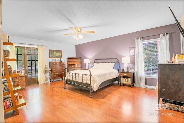 651 Olive Ave, Fairhope, AL 36532 - bedroom with wood finished floors, french doors, access to outside, and a ceiling fan
