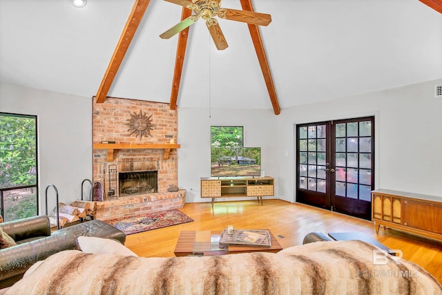 651 Olive Ave, Fairhope, AL 36532 - living room featuring french doors, beamed ceiling, wood finished floors, a ceiling fan, and a fireplace