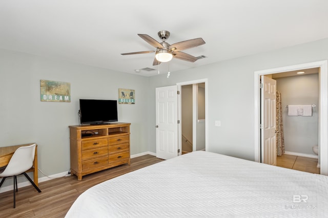 bedroom with light wood-type flooring, connected bathroom, and ceiling fan