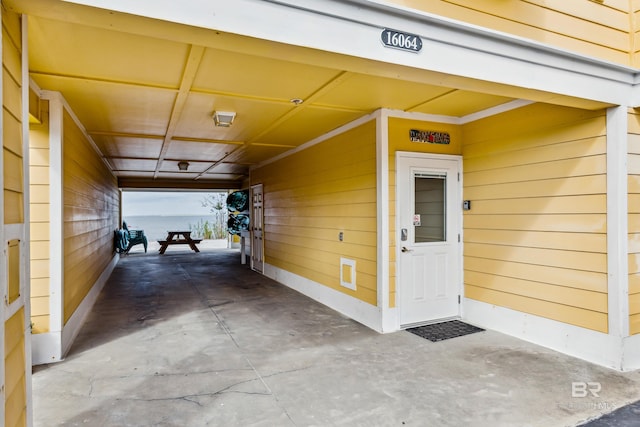 view of exterior entry featuring a carport