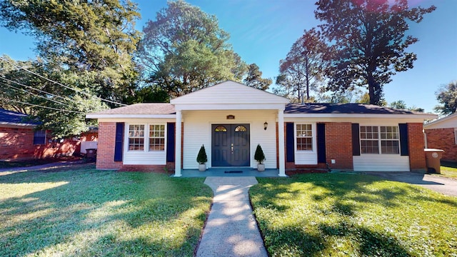 ranch-style home featuring a front yard and a porch