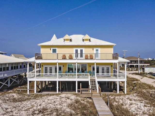 back of property featuring metal roof, french doors, and a balcony