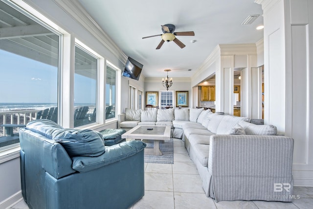 living area featuring light tile patterned floors, visible vents, crown molding, and ceiling fan with notable chandelier