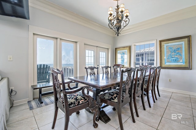 dining space with light tile patterned floors, french doors, an inviting chandelier, and crown molding