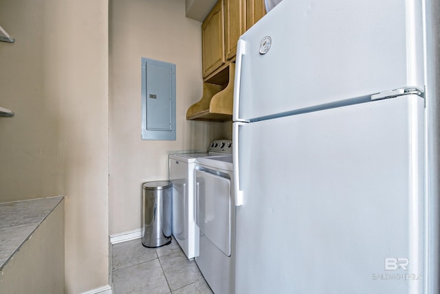 washroom with cabinet space, light tile patterned floors, electric panel, baseboards, and washing machine and dryer