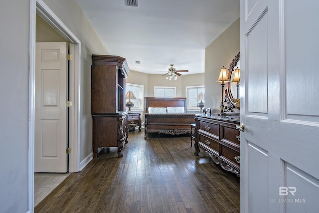 bedroom with dark wood-style floors and visible vents