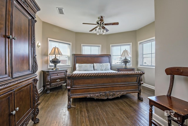 bedroom featuring dark wood-style flooring, visible vents, baseboards, and multiple windows