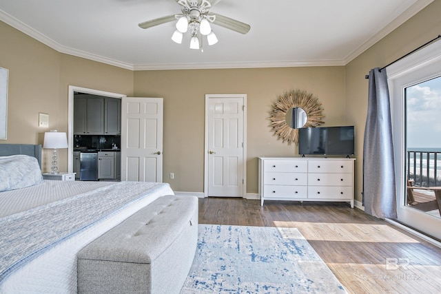 bedroom with a ceiling fan, crown molding, baseboards, and wood finished floors