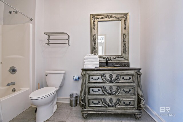 bathroom with toilet, tile patterned flooring, baseboards, and tub / shower combination