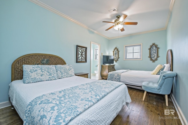 bedroom featuring dark wood finished floors, visible vents, crown molding, and baseboards