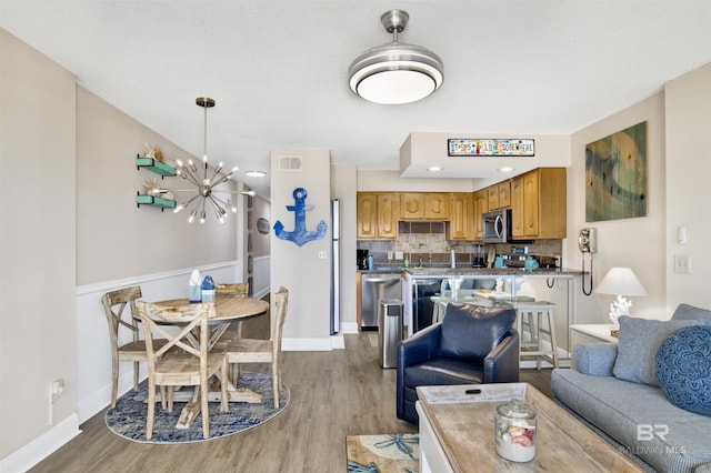 409 E Beach Blvd Unit 184, Gulf Shores, AL 36542 - living area featuring wood finished floors, a chandelier, and baseboards