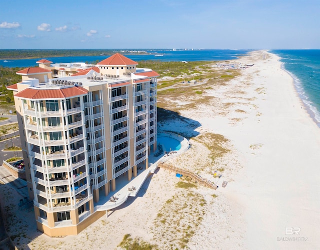 aerial view with a water view and a beach view