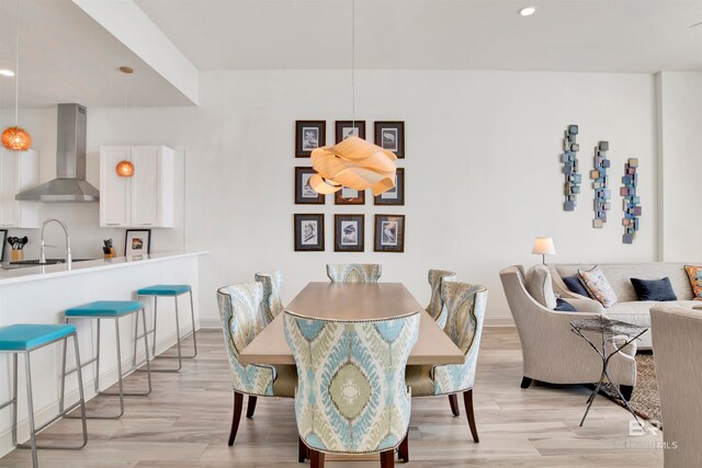 dining space featuring light hardwood / wood-style floors and sink