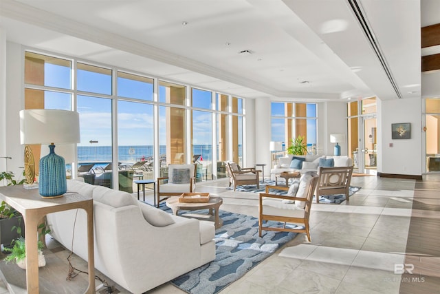 living room with a wall of windows and a water view