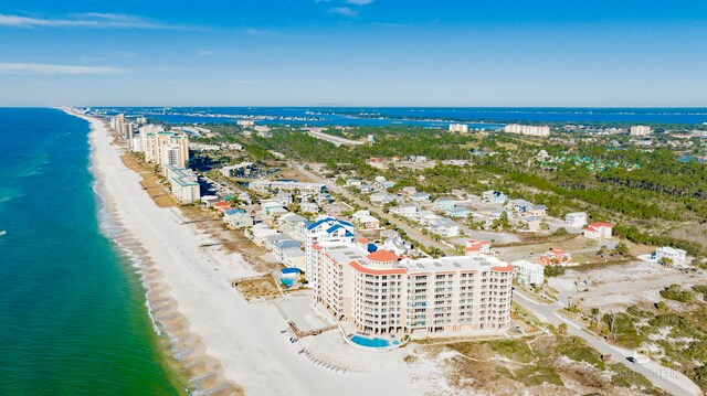 bird's eye view featuring a water view and a beach view