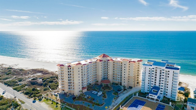 drone / aerial view with a water view and a beach view