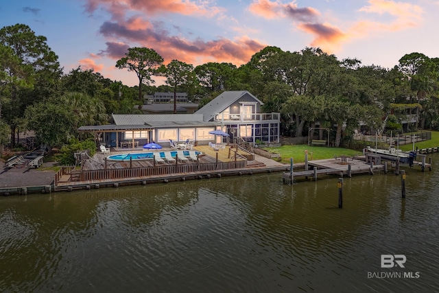 back house at dusk with a water view