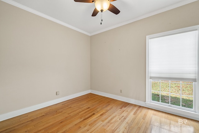 empty room with baseboards, ornamental molding, light wood finished floors, and a ceiling fan