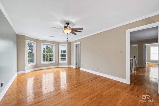 unfurnished room featuring ceiling fan, ornamental molding, baseboards, and light wood-type flooring