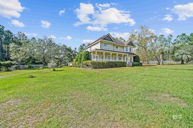 exterior space with a porch, fence, and a front lawn