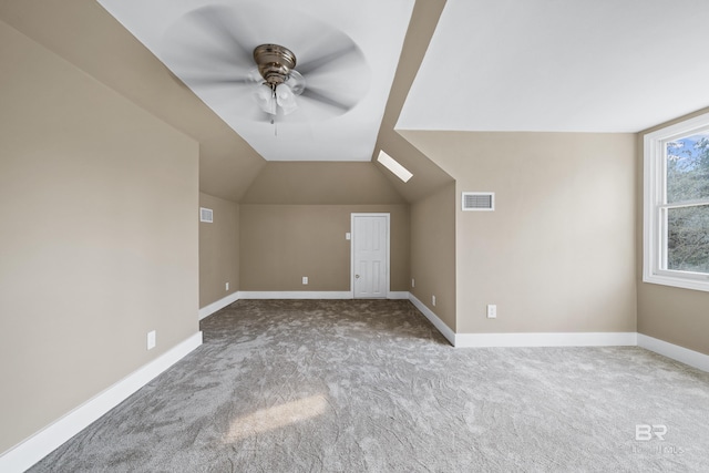bonus room featuring a ceiling fan, baseboards, visible vents, and carpet