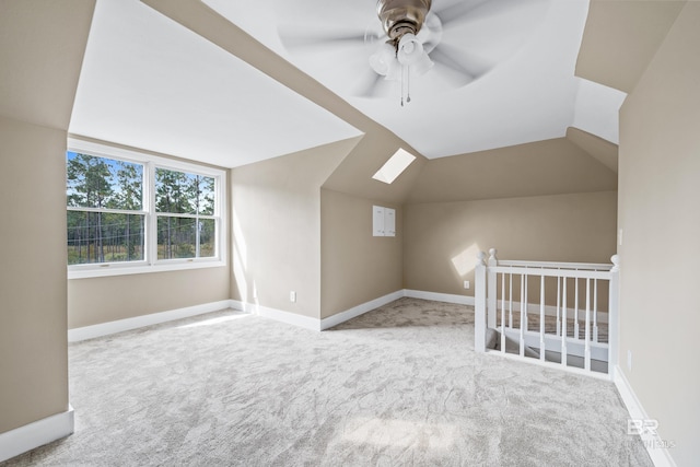 bonus room featuring carpet flooring, ceiling fan, baseboards, and lofted ceiling