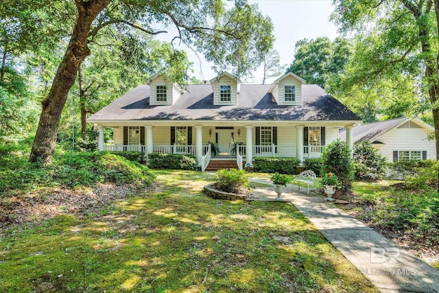 cape cod home with a porch and a front lawn