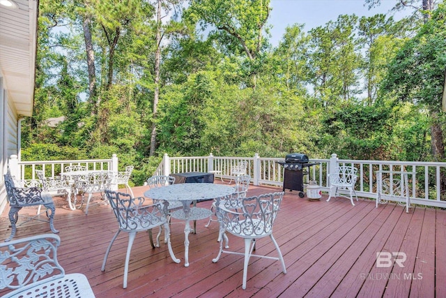 wooden deck with a grill