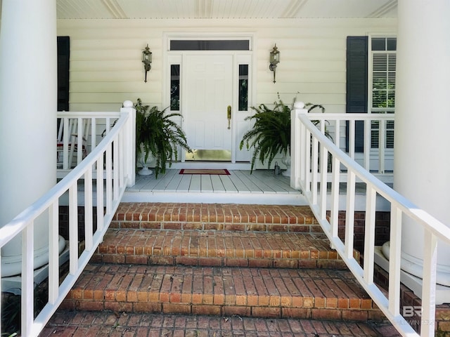 view of exterior entry with a porch