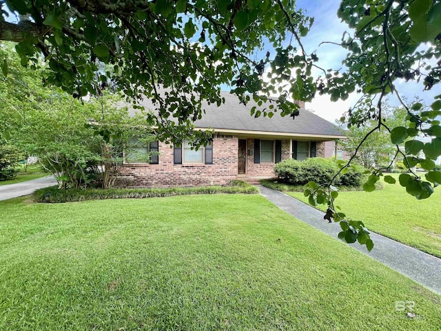 506 Evergreen Ave, Brewton, AL 36426 - view of front facade featuring brick siding, a front lawn, and roof with shingles