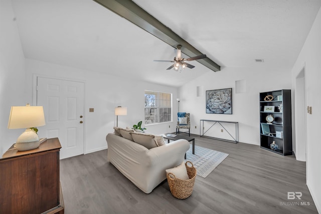 living room featuring visible vents, baseboards, lofted ceiling with beams, wood finished floors, and a ceiling fan