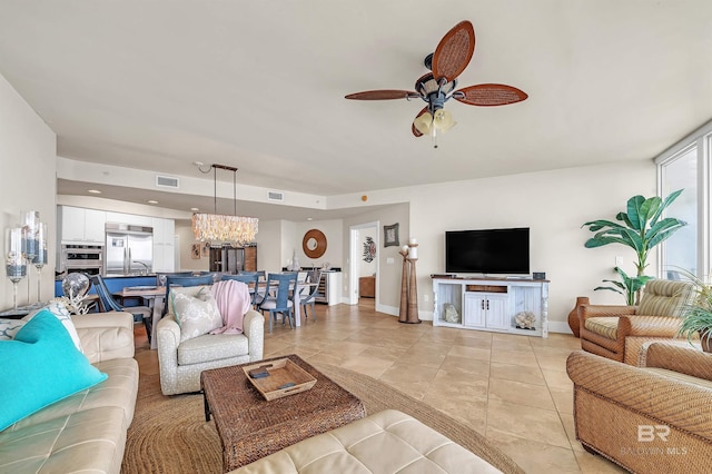28107 Perdido Beach Blvd Unit D1005, Orange Beach, AL 36561 - living room with light tile patterned floors, ceiling fan, and a chandelier