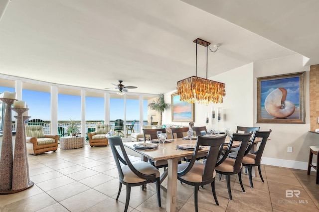 28107 Perdido Beach Blvd Unit D1005, Orange Beach, AL 36561 - dining room with expansive windows, a ceiling fan, a chandelier, and light tile patterned floors
