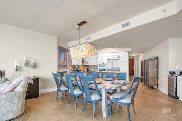 28107 Perdido Beach Blvd Unit D1005, Orange Beach, AL 36561 - dining area featuring a chandelier, recessed lighting, and light tile patterned floors