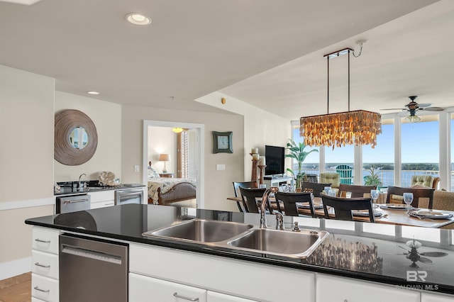 28107 Perdido Beach Blvd Unit D1005, Orange Beach, AL 36561 - kitchen with stainless steel dishwasher, dark countertops, a ceiling fan, white cabinetry, and recessed lighting