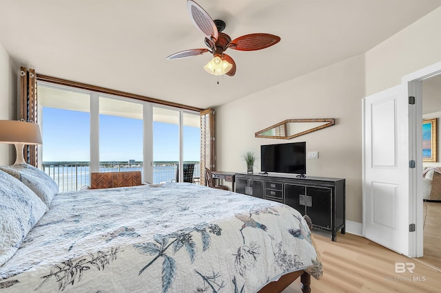28107 Perdido Beach Blvd Unit D1005, Orange Beach, AL 36561 - bedroom with light wood-type flooring, access to outside, a ceiling fan, and a wall of windows
