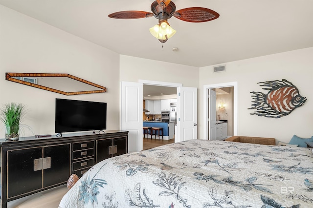 28107 Perdido Beach Blvd Unit D1005, Orange Beach, AL 36561 - bedroom with ensuite bath, wood finished floors, and a ceiling fan
