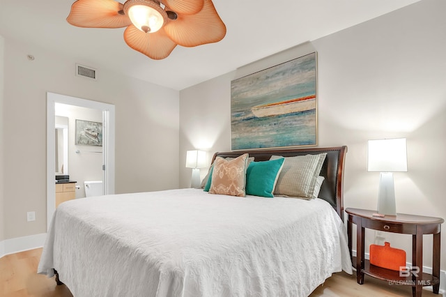28107 Perdido Beach Blvd Unit D1005, Orange Beach, AL 36561 - bedroom with wood finished floors, ensuite bath, and a ceiling fan