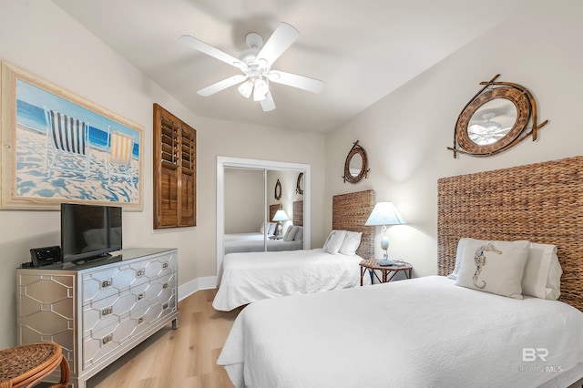 28107 Perdido Beach Blvd Unit D1005, Orange Beach, AL 36561 - bedroom with light wood-style flooring, a closet, and a ceiling fan