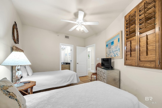 28107 Perdido Beach Blvd Unit D1005, Orange Beach, AL 36561 - bedroom with wood finished floors, ensuite bathroom, and ceiling fan
