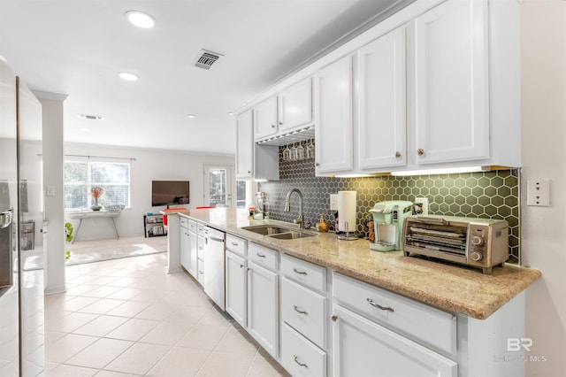 kitchen featuring white cabinetry, sink, dishwasher, and light stone countertops