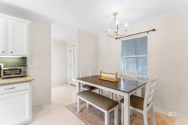 dining area featuring light tile patterned floors, a chandelier, and ornamental molding