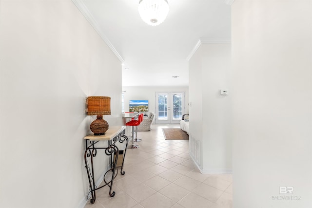 hallway with ornamental molding, light tile patterned floors, and french doors